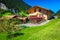 Modern alpine wooden house with orderly garden in Switzerland