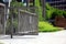 Modern aluminum powder coated fence and gate. perspective street view.