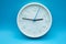 modern analog clock on blue background