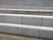 Modern angled outdoor steps with rounded corners int textured grey and brown colors