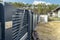 Modern anthracite panel fence, visible sliding gate to the garage, view from the garden.