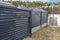 Modern anthracite panel fence, visible sliding gate to the garage, view from the garden.