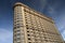 Modern apartment building exteriors against a blue sky with clou