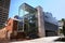 Modern architectural glass stairwell extension added to existing old historic brick building in Sydney Mint in urban downtown CBD