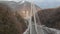 Modern architectural object, aerial view of new cable-stayed bridge near mountains at winter day