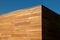 Modern Architecture detail of red cedar cladding wood facade, geometric shape, minimalist esthetics