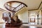 Modern architecture interior with classic elegant luxury hallway with curved glossy wooden staps stairs in modern storey house