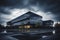 Modern architecture of office building made of steel-colored glass against cloudy sky with clouds. Dusk, early evening