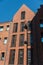 Modern architecture in the old port area of Gdansk, Poland. Red brick building with shuttered windows