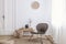 Modern armchair and pouf on brown carpet in white apartment interior with door. Real photo