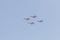 Modern armed military fighter jets flys in formation through the sky