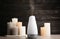 Modern aroma humidifier with candles on table against dark wooden background