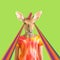 Modern art collage. The figure of a girl with a deer head with a unicorn horn on a green background with rays from the eyes.