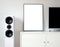 Modern audio stereo system with white speakers on bureau in modern interior