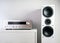 Modern audio stereo system with white speakers on bureau in modern interior