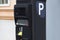 Modern automatic pay Parking meter or ticket payment station  on a street allow parkers, car drivers pay by card or cash