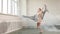 Modern ballet dancer in scenic flowing costume working out at studio, slow motion