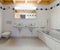 Modern bathroom in an empty and refurbished apartment with two sinks and a bathtub