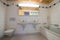 Modern bathroom in an empty and refurbished apartment with two sinks and a bathtub