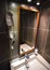 Modern bathroom in hotel room, white porcelain wash basin, mirror and hair dryer on the wall. Wide angle photo.