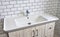 Modern bathroom Interior with design washbasin on a background of white ceramic tiles. Faucet for water at the white wall