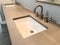 Modern bathroom with quartz countertop, two sinks and faucets with stone floor