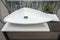 Modern bathroom white ceramic sink bowl rounded tryangle shape with chrome fixtures and plant