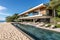 Modern beachfront house with pool on ocean shore.