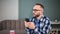 Modern bearded guy in trendy glasses chatting use smartphone. Shot on RED Raven 4k Cinema Camera
