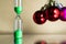 Modern beautiful green hourglass with christmas or xmas and new year balls.