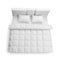 Modern bed with comfortable soft mattress and blanket on white background