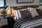 Modern bedroom with brown, black and white striped pillows