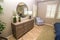 Modern Bedroom With Circular Mirror & Wooden Dresser