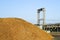 Modern biomass cogeneration power plant equipment with a mountain of wood chips in the foreground