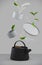 Modern black cast iron teapot with levitation cups, leaf tea and water, artistic background set, art set for tea time. 3d renderin