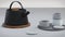 Modern black cast iron teapot and tea cups and a minimalist table white. side view, set for tea time. 3d rendering