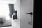 Modern black door handle and lock on black wooden hidden door. Close-up elements of the modern interior of the apartment