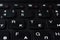 Modern black laptop keyboard closeup, english alphabet