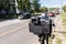 modern black professional mirrorless camera on tripod or monopod shooting city car traffic at summer day