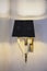 Modern black wall lamp with white fangs. Beautiful decor of a fashionable chandelier