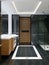 Modern bleack and white designer bathroom with black marble shower tiling