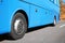 Modern blue bus on road, focus on wheel