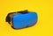 Modern blue glasses of virtual reality for smartphone and phone on yellow background, close-up, multimedia, video game