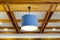 Modern blue hanging lamp on wooden ceiling