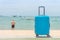 Modern blue rolling hard baggage on beach