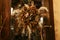 Modern boho christmas wreath made of dried herbs on storefront door in evening