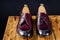 Modern Bordeaux color men`s loafers over black background.