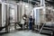 Modern brewery facility with large stainless-steel tanks, pipes, and workers monitoring the beer production process