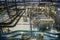Modern brewery production line, aerial view. Conveyor belt, pipeline for ingredient delivery, machinery, tools, vats