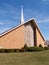 Modern brick church with white steeple